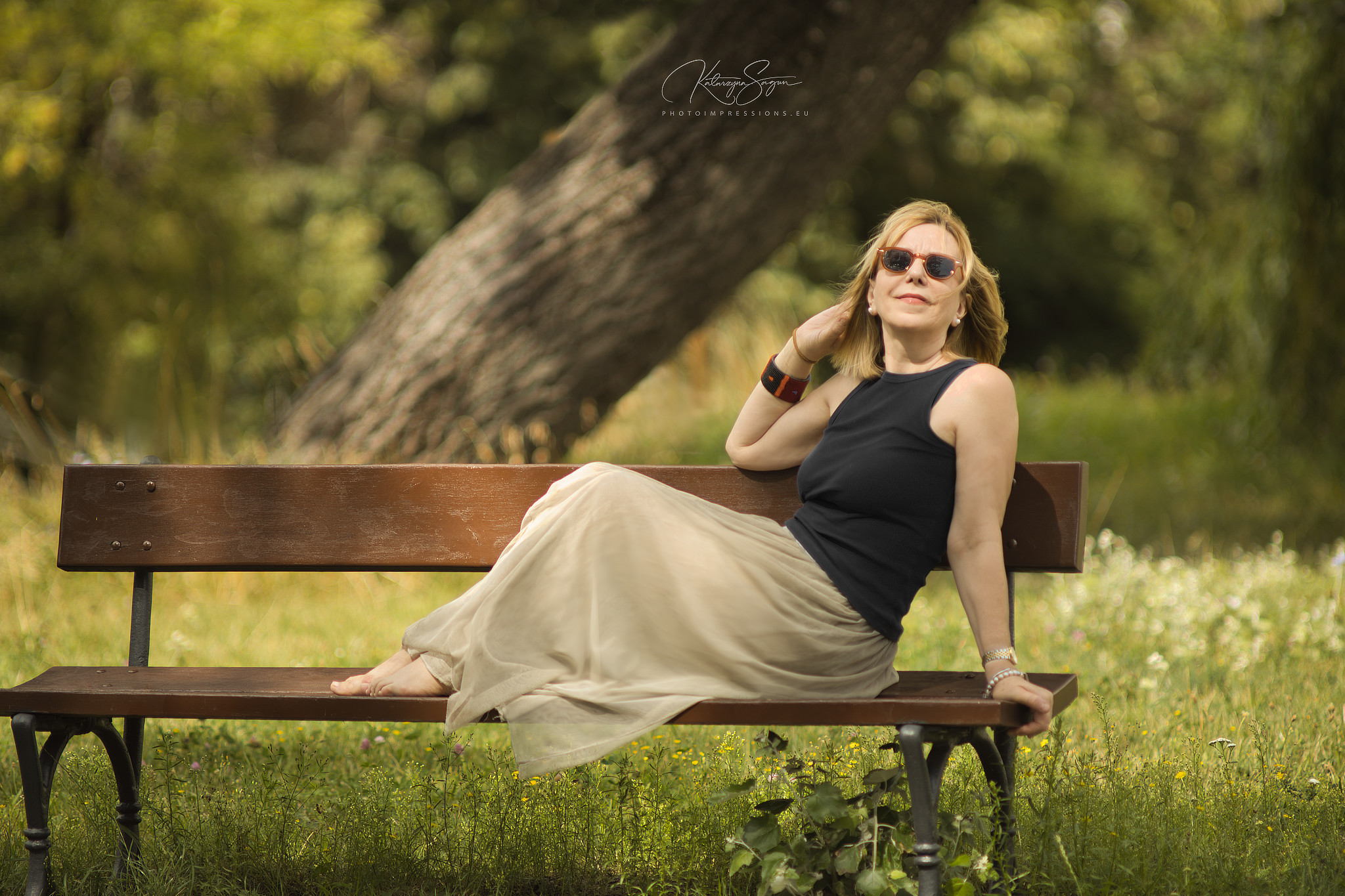 Solo artistic portrait of a mature woman sitting on a park bench in Iceland.