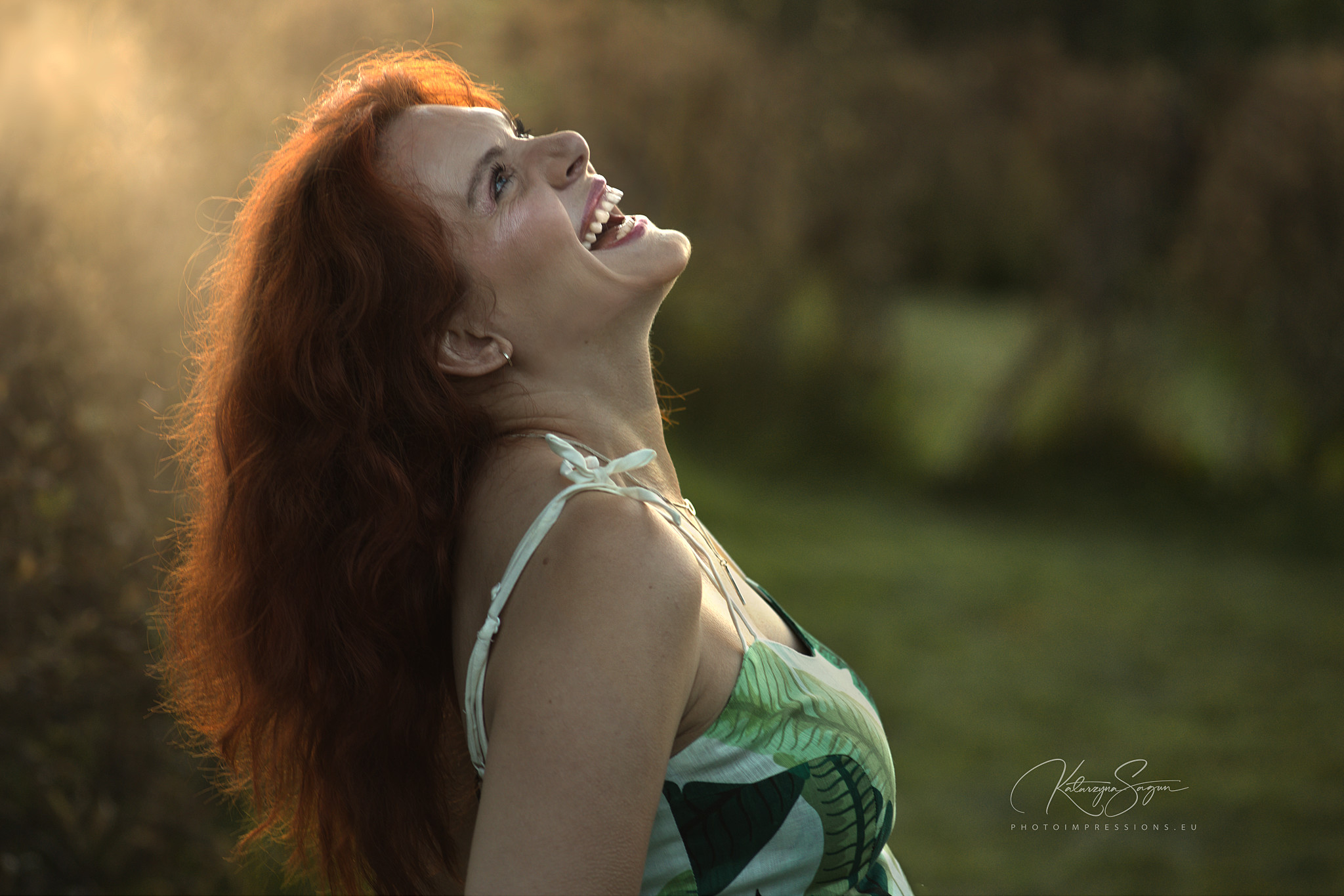 Close-up portrait of a red-haired woman outdoors in Iceland.